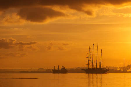 Sail boat at sunrise in Havana port, Cubaの写真素材