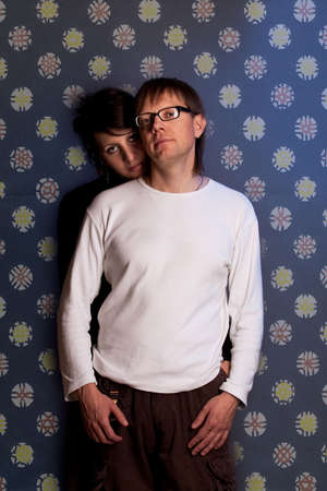 young nice couple together over flowery backgroundの写真素材