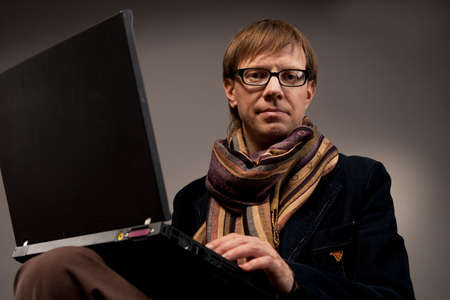 pretty young man with laptop in jacket isolated