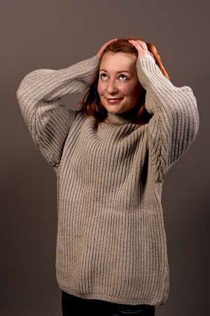 young surprised woman with smile in sweater isolated