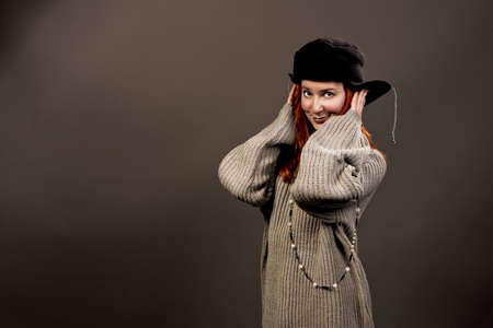 pretty young girl in winter sweater and hat isolated