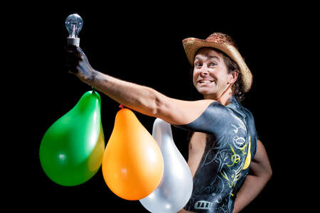 happy handsome cowboy with lamp and baloons isolated の写真素材