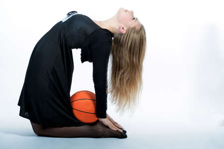 acrobatic blond woman isolated over whiteの写真素材