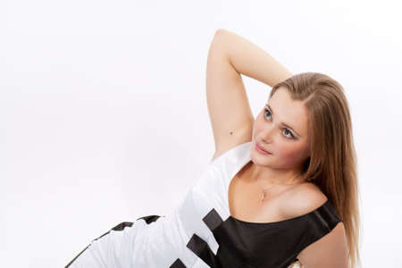 sensual and sexy pretty caucasian blond on floor in piano like dress relaxing isolated over whiteの写真素材