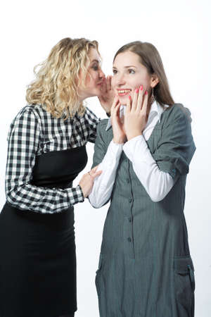 two girlfriends sharing rumors with each other isolatedの写真素材