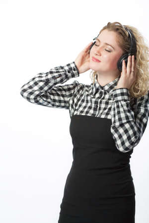 blond caucasian girl in headphones listening to music isolated の写真素材