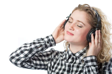 blond caucasian girl in headphones listening to music isolated の写真素材
