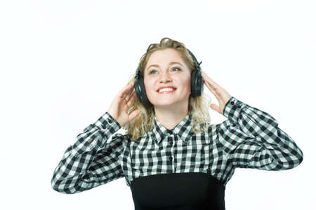 happy blond caucasian girl in headphones listening to music の写真素材