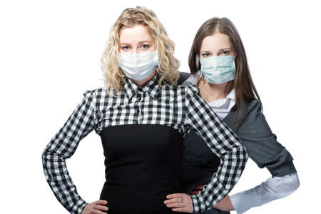 girls in medical masks standing together against viruses の写真素材