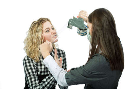 two young caucasian girls playing with tape isolated の写真素材