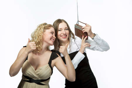 happy girlfriends with radio isolated over white background の写真素材