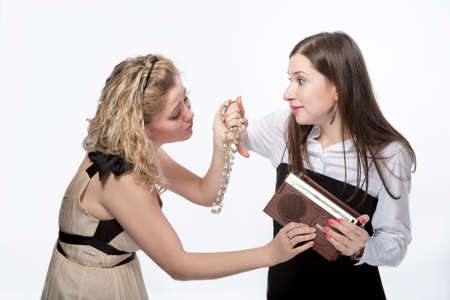 two girlfriends having fun with old radio isolated over white の写真素材