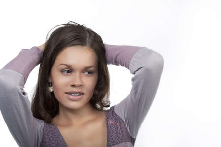 girl wearing brace system standing relaxing with hands lifted and isolated over white