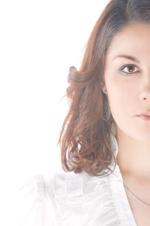 sensual cute caucasian brunette woman standing in white shirt over pure white background.shoot made in high key technique.の写真素材