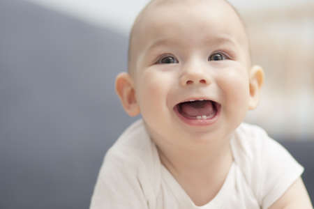 lovely portrait of little caucasian tot gesturing and smiling happily indoorsの写真素材