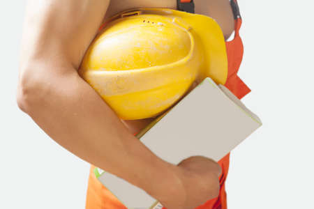 fragment shot of a strong builder man with papers holding protective helmet on hand