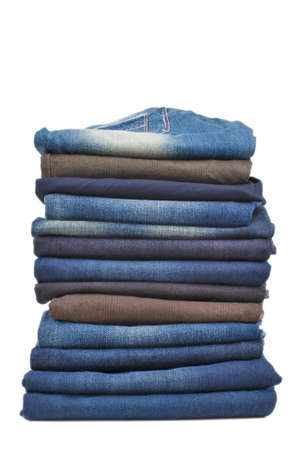 bale of jeans one over another isolated on pure white backgroundの写真素材