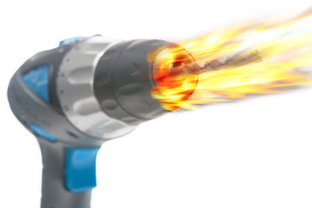 electric portrable drill burning in fire, composite image isolated on white, horizontal imageの写真素材