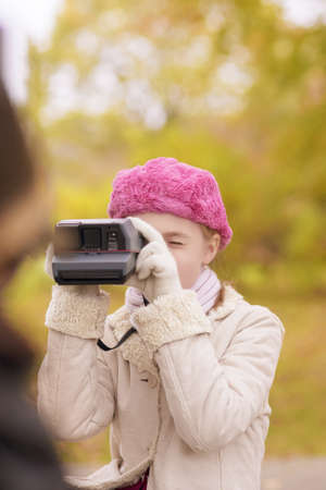 portrait of two kids photographing outside in the park area