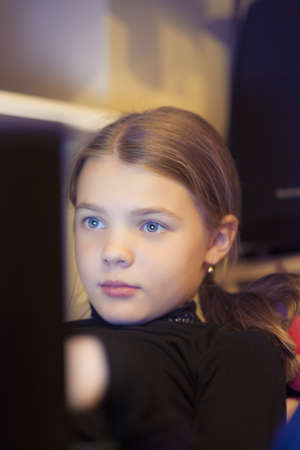 little girl chatting on laptop indoorsの写真素材