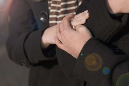 two connected palms of young caucasian couple standing close togetherの写真素材