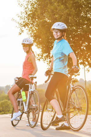 Nice portrait of two female athletes standinh together and resting outdoors  vertical imageの写真素材