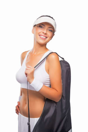 Portrait of Caucasian Tanned Professional  Tennis Player  in Brand New Outfit With Tennis Bag Ready For Game. Against Pure White. Vertical Imageの写真素材