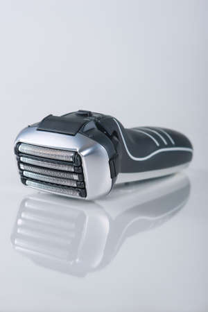 Ultramodern 5 Blades Electric Foil Arc Shaver On Reflecting Surface. 