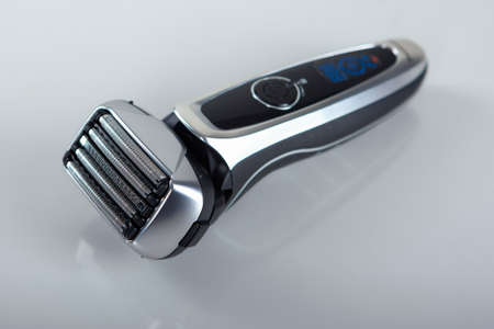Ultramodern Five Blades Electric Shaver On Smooth Reflecting Surface. Vertical Imageの写真素材