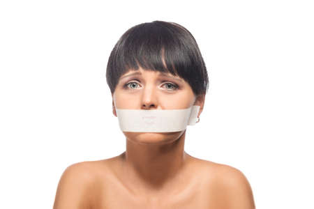 Family Violence Concept: Portrait of Brunette Woman with Her Mouth Sealed with Tape. Isolated Over...