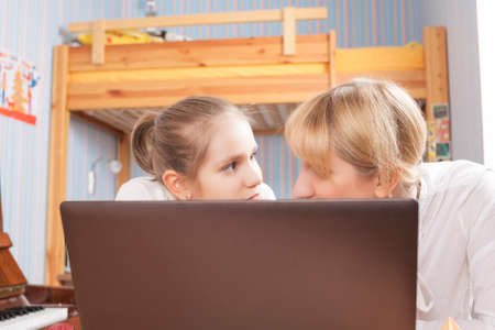 Mother and Daughter In Front of computer Screen. Horizontal Imageの写真素材