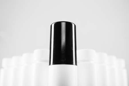Bottle With Black Cap Against Similar White:Leadership Concept. Horizontal Image