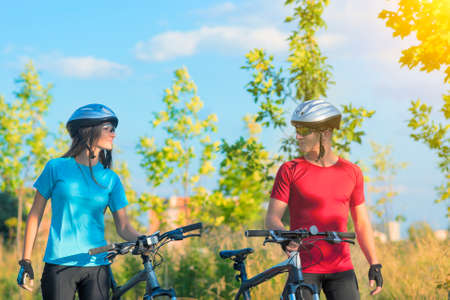 Loving Sensual Caucasian Couple with Bicycles Walking Outdoor. Horizontal Image Compositionの写真素材
