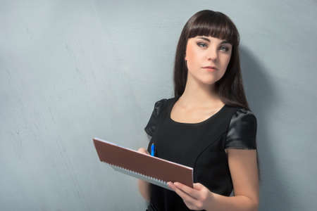 Confident Young Brunette Woman With Personal Organizer. Horizontal Imageの写真素材