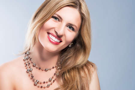 Portrait of a Smiling Happy Blond Woman. Long Hair and Brilliant smile. Horizontal Imageの写真素材