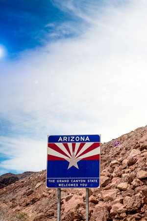 Arizona State Border Highway Sign Against Sky Blue Background. Light Effect Used. Vertical Image Compositionの写真素材