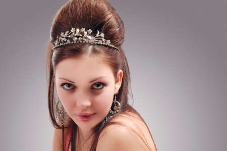 Portrait of Sexy and Sensual Caucasian Young Female with Crown Over Gray Background. Horizontal Image Composition.の写真素材