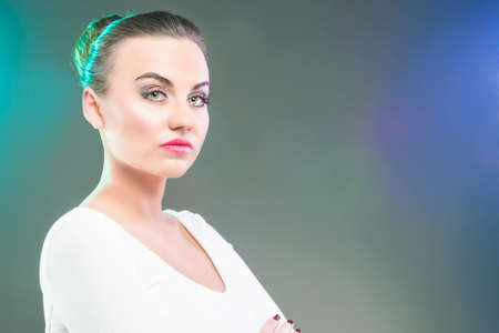 Portrait of Serious Brunette Woman Over Gray Background. Horizontal Image Compositionの写真素材