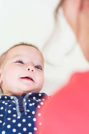 Cute portrait of Newborn Caucasian Girl Smiling.Verical Image