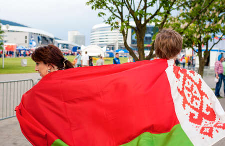Minsk-Belarus, May, 20: Two Ice-Hockey Fans In Minsk Holding Belarussian Flag Prior to International Ice Hockey Championship on May 20, 2014 in Minsk, Republic of Belarusのeditorial素材