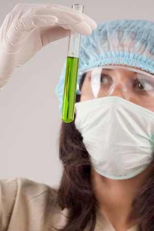 Female Caucasian Doctor With Test Tube. Isolated on Gray Background. Vertical Image Compositionの写真素材