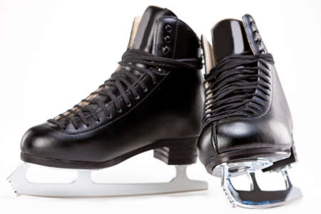 Pair of Black Professional Figure skates With Sharp Blades Over White Background. Horizontal Image Compositionの写真素材