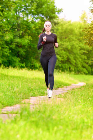 Caucasian Sportwoman Having Her Regular Training Outdoors. Vertical Composition