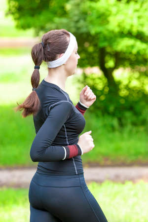 Sport Training Concept: Back View of Caucasian Brunette Woman Running Fast. Vertical Image...