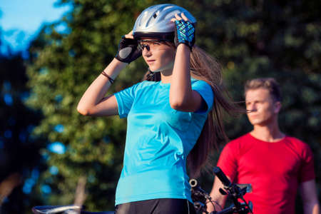 Portrait of Professional Cycling Couple Standing Together Outdoors. Horizontal Image Compositionの写真素材