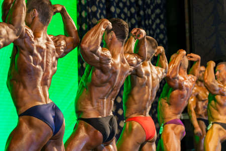 MinskBelarus April 26: Professional Bodybuilders Performing on Stage during Bodybuilding and Fitness Championship of the Republic of Belarus on April 26 2015 in Minsk Republic of Belarusのeditorial素材