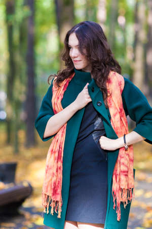Fashion and Style Concept: Portrait of Young Caucasian Brunette Female in Made to Measure Clothing. Outdoors Photoshot. Vertical imageの写真素材