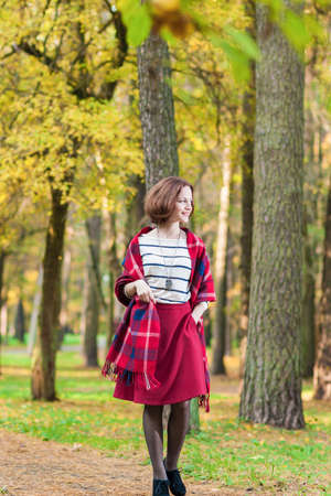Female Fashion Model Having a Stroll in the Forest Outdoors. Vertical Imageの写真素材