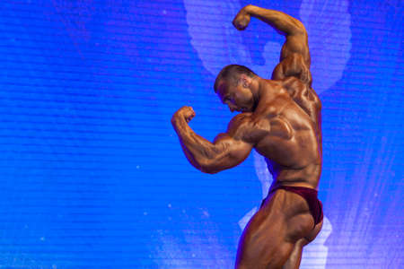Minsk-Belarus, April, 26: Professional Male Caucasian Bodybuilder Performing on Stage during Bodybuilding and Fitness Championship of the Republic of Belarus on April, 26, 2015 in Minsk, Republic of Belarusのeditorial素材