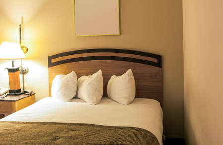Classic Bedroom Enterior with King Size Bed and Line of Arranged Pillows. Evening Time...